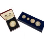 A collection of commemorative coins and medallions, including a 1977 Spink & Sons cased silver