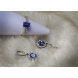 A modern tanzanite and diamond ring and pair of earrings, the 18ct white gold ring having