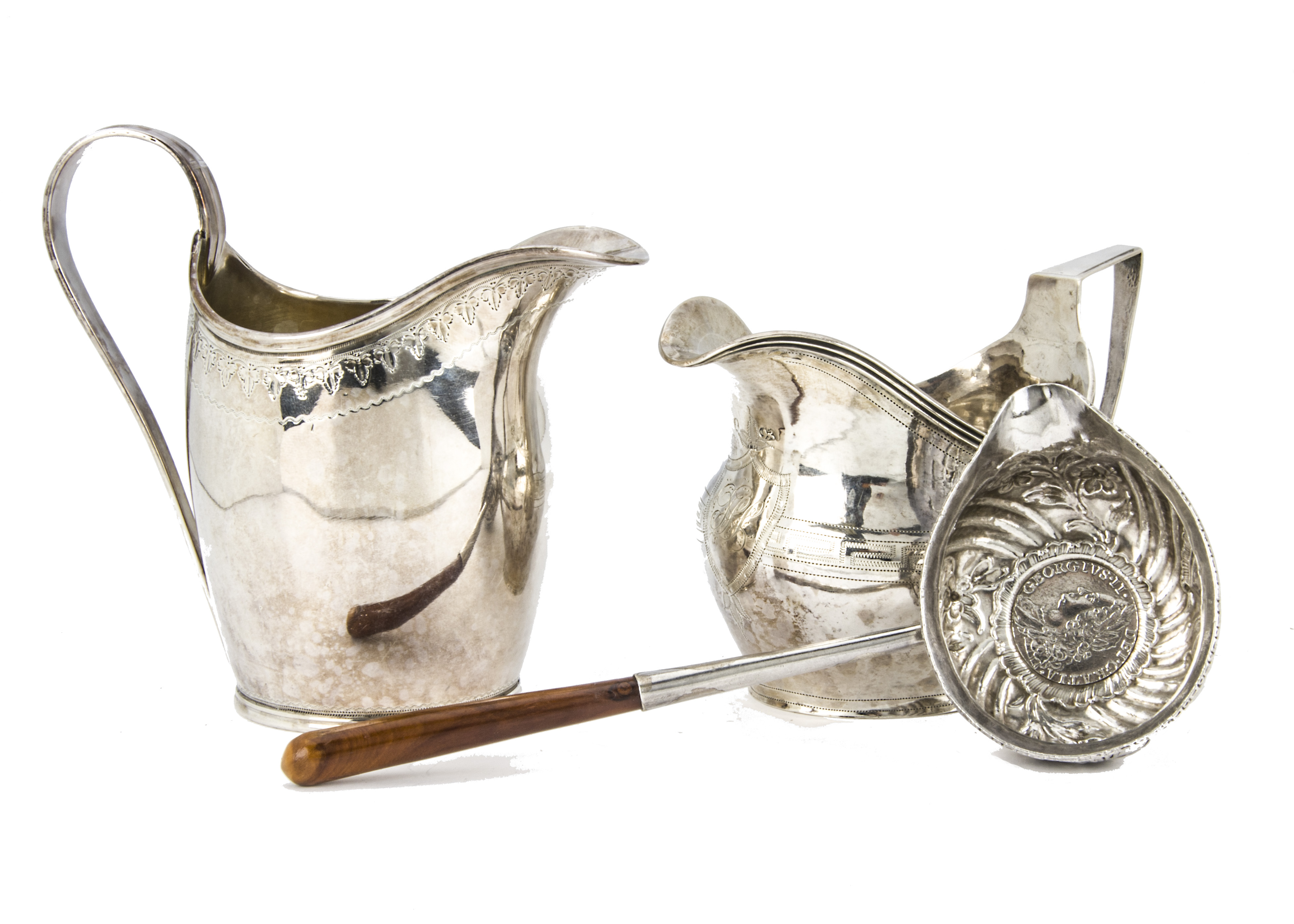 Two George III period silver helmet shaped milk jugs, one marked Birmingham 1799 by George Ashworth,