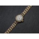 A vintage 9ct gold Tudor Royal lady's wristwatch, circular case on textured link bracelet, appears