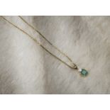 A modern 18ct gold emerald and diamond pendant, on a fine box link 18ct gold chain, 3.2g