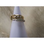 An Art Deco 18ct gold and platinum three stone diamond ring, 3.1g and size N, together with a 15ct