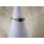 A 1980s 18ct gold sapphire and diamond ring, having oval central blue stone and six brilliant cuts