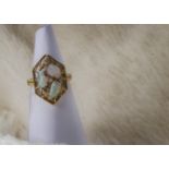 A retro 14ct gold opal and diamond dress ring, the web like pierced hexagonal tablet set with