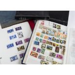 A collection of British and World stamps, in five books and folders, including two penny reds,