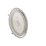 A George III silver teapot stand by John Crouch I & Thomas Hannam, oval form with bead rim, engraved