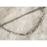 A modern 9ct white gold "Kiss" necklace and bracelet set, having X shaped links and alternating