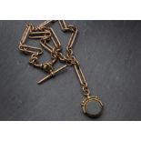 A Victorian 9ct gold double Albert watch chain, having long and circular links, supporting a