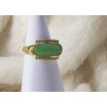 A 1970s Chinese hardstone and diamond dress ring, the oval jade style green stone having applied row
