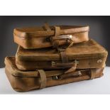 A set of three 1960s graduated tan leather suitcases from Harrods, widest 75cm, each with wear and