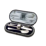 A Victorian silver Christening set by Edward Hutton, the fitted case with initials supporting an Old