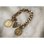 A heavy 9ct gold bracelet with two sovereigns, the flattened curb link hallmarked chain with a heart