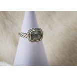 A modern silver and gem set ring by David Yurman, having a pale green facet top stone with small
