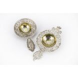 Two early 20th century silver tea strainers by Berthold Hermann Muller, one of pierced design, the