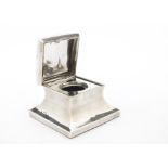 A late Victorian glass desk inkwell from Mappin Bros, square form with hinged cover, glass liner,