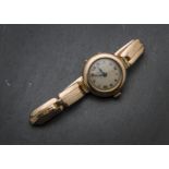 An Edwardian or later 9ct gold lady's trench style wristwatch, on a 9ct gold expanding strap, 20g