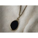 A nice vintage hardstone locket pendant on chain, the hinged yellow metal frame having on onyx and