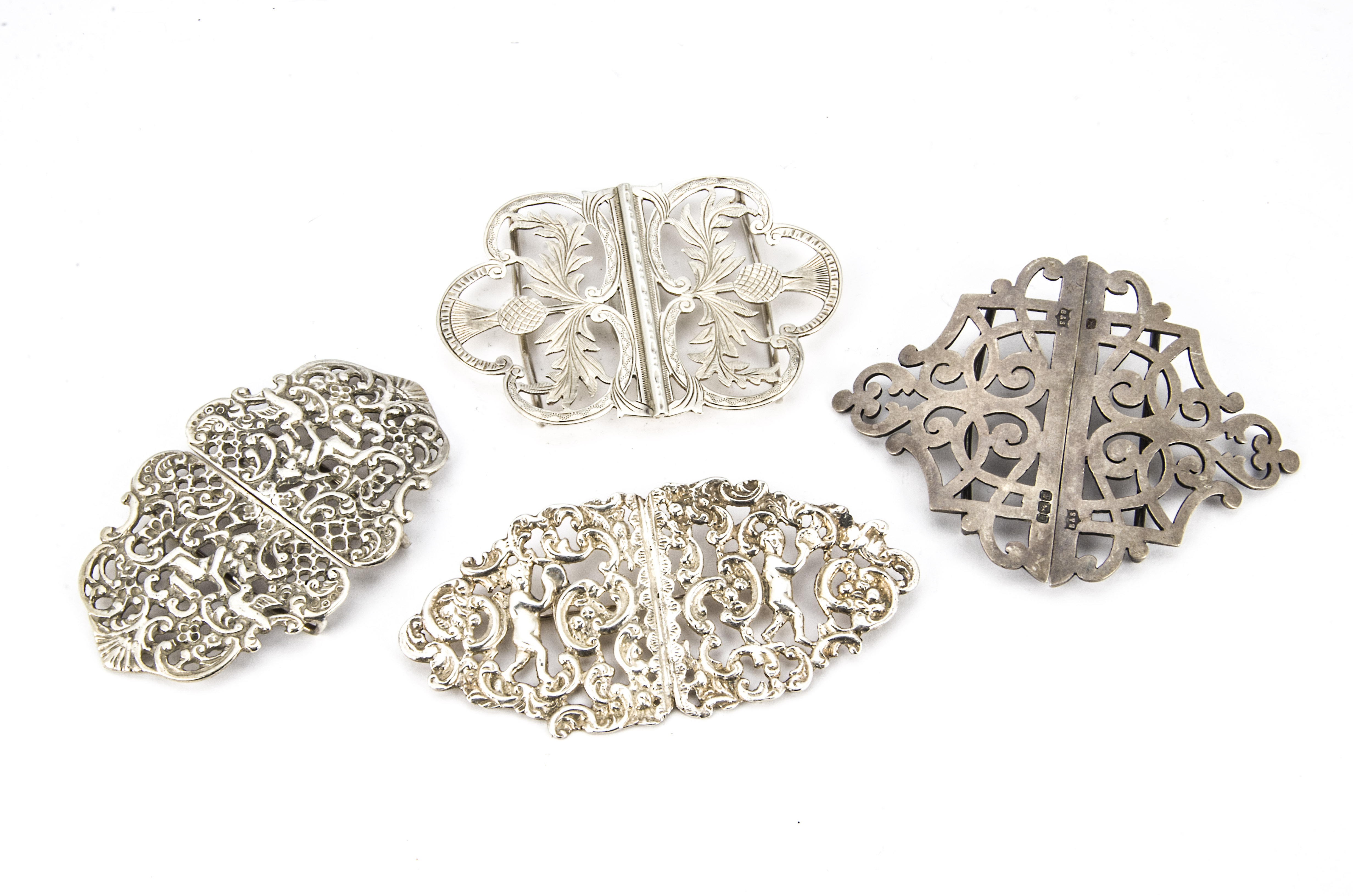 A group of 4 Victorian and modern silver nurses buckles, one now converted to a brooch, another with