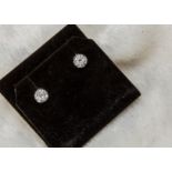 A pair of 1980s 14ct white gold and diamond stud earrings, circular mounts set with five brilliant