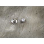 A pair of modern 18ct white gold and diamond ear studs, each eight claw post setting earring with