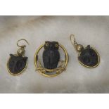 A late Victorian period Black Forest brooch and pair of earrings, the circular gilt brooch mount