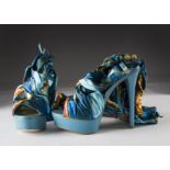 A pair of modern Scarlett high heel shoes by Bebe, size 7, in turquoise and wrap around bright
