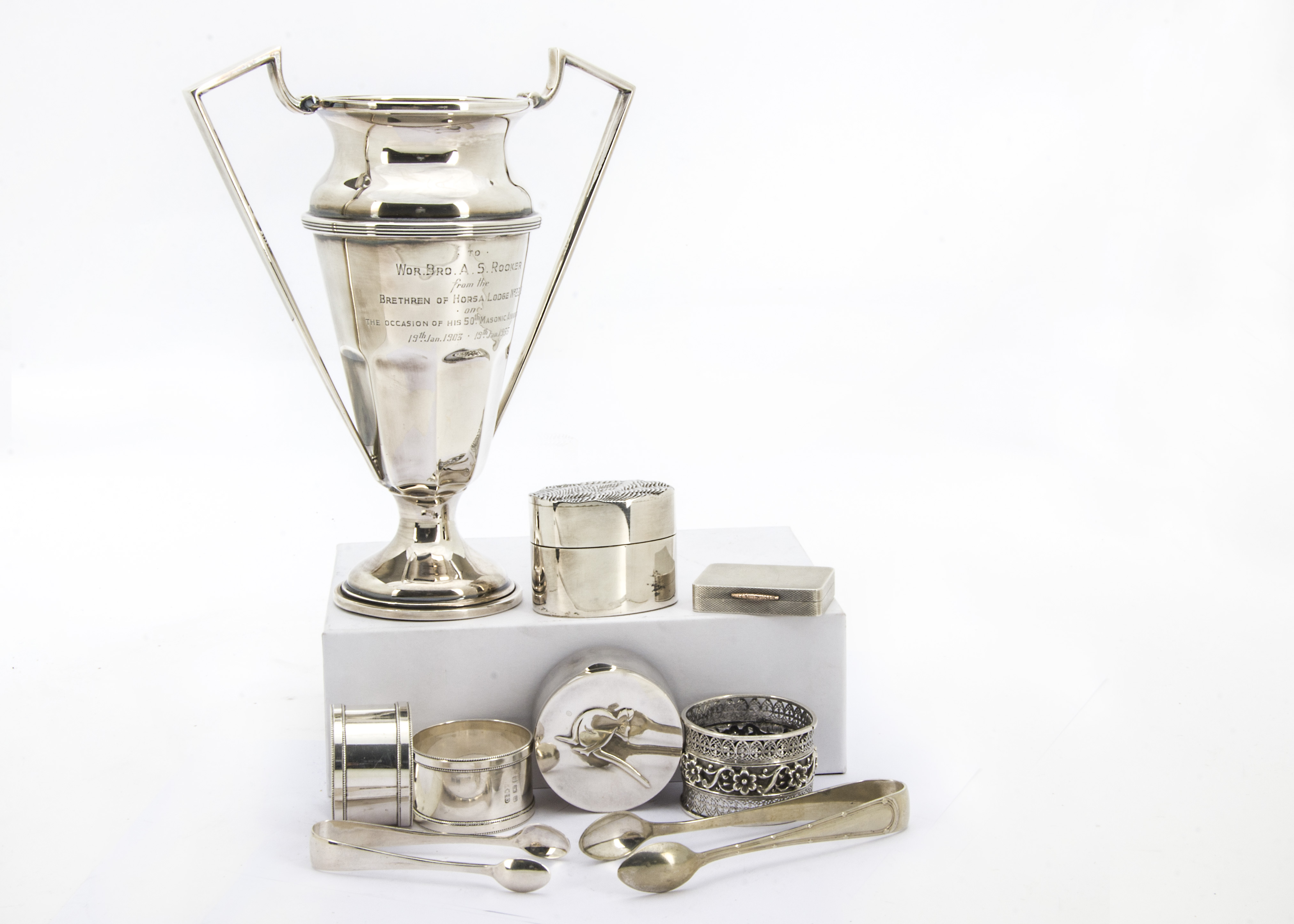 A collection of silver and silver plated items, including a 1950s silver marked trophy cup, six