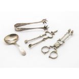 A George III period silver brightcut design tea caddy spoon by RJ, together with a pair of similar