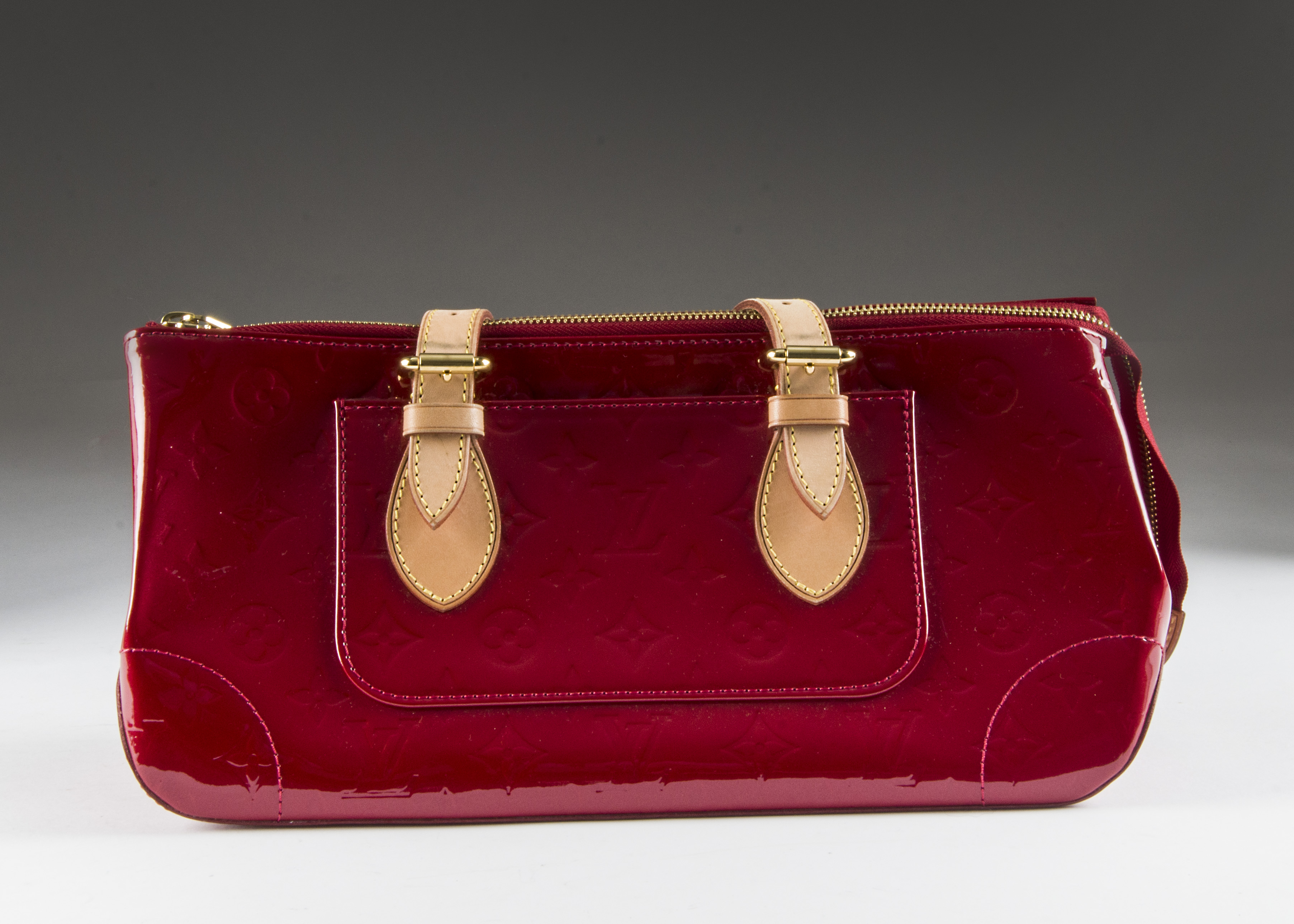 A modern red patent handbag marked Louis Vuitton, having tan coloured straps, in Louis Vuitton