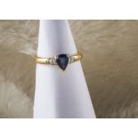 A modern 18ct gold Ceylon sapphire and diamond ring, with pear shaped blue stone and diamond set