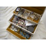 A collection of jewellery, presented in a three tier jewellery box, including earrings, rings,