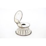 A 1920s silver desk inkwell by JP & Co, circular with impressed lines and hinged top, lift off cover