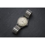 A 1940s Omega stainless steel gentleman's wristwatch, once luminous Arabic numerals to cream