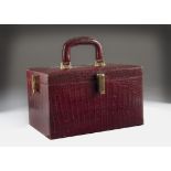 A 1950s red snakeskin vanity case, with gilt clasps, 31.5cm wide, some scuffs and marks