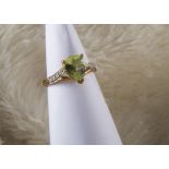 A modern 9ct gold cuprian tourmaline ring, heightened by diamonds to split shoulders, 2.5g and