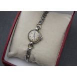 A vintage Tudor lady's wristwatch, circular chromed case, grubby dial, appears to run, on later