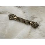 A late 19th century Middle Eastern gilt brooch, probably silver, with mesh central bar and dragon