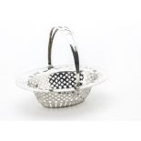 An Edwardian silver bon bon dish by CBT, the oval pierced dish with swing handle