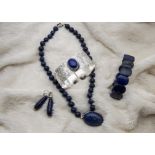 An associated modern suite of lapis lazuli jewellery, including a bracelet, a cuff bangle, bead