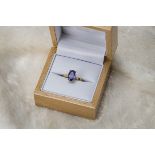 A modern 18ct gold and tanzanite solitaire ring, oval blue stone in hallmarked yellow 18ct gold