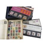 A collection of stamps and cigarette cards, including 25 Royal Mint Millennium Collection mint