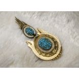 A Victorian mourning brooch, the archaeological revival piece with white enamel and turquoise beads,