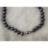 A modern pearl necklace, the string of cultured Tahitian style black pearls having white 9ct gold