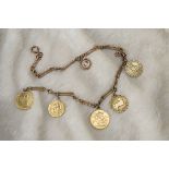 A 9ct gold watch chain with three gold coins and medallions, the hallmarked fancy link chain