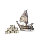 A 1960s Arabic white metal model of a dhow on stand, stamped Cheeky Jewellers Sharjah, with