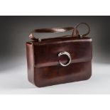 A modern leather handbag by Cartier, in dark brown, with C shaped panther clasp, very good