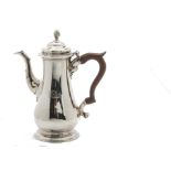 A George III silver hot water pot by Fuller White, hinged domed cover with flame finial, on tapering