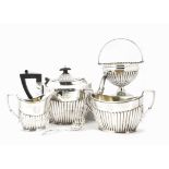 A late Victorian five piece tea and coffee set by James Dixon & Sons, helmet shaped with fluted
