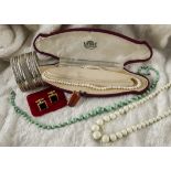 A collection of jewellery, including a single strand pearl necklace, two glass bead necklaces,