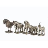 Five Far Eastern white metal animal figures, including two mules, a bird, an elephant and a temple
